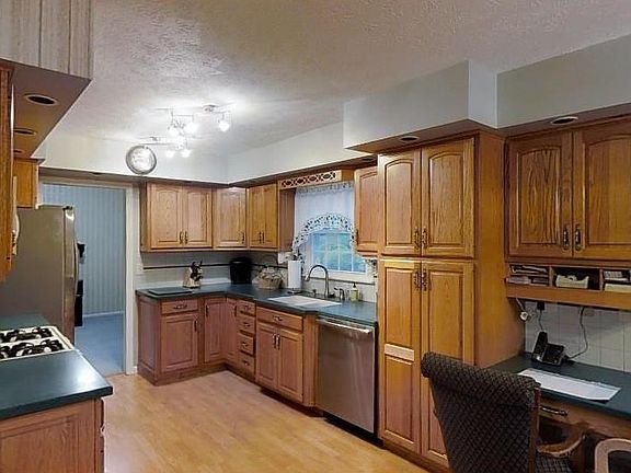 Bright, well lit kitchen with lots of cabinet, counter space and a recipe desk. Nice flow into dining and living rooms.