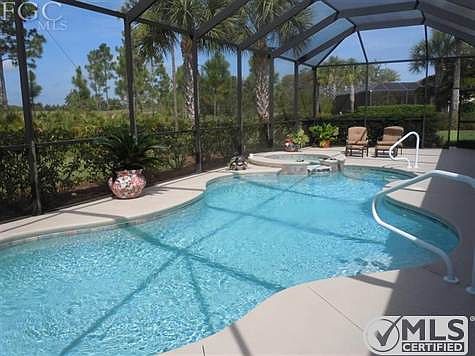 Beautiful large pool and spa, extended lanai and screen enclosure.  Surface just painted.  Stunning views of the golf course from the lanai