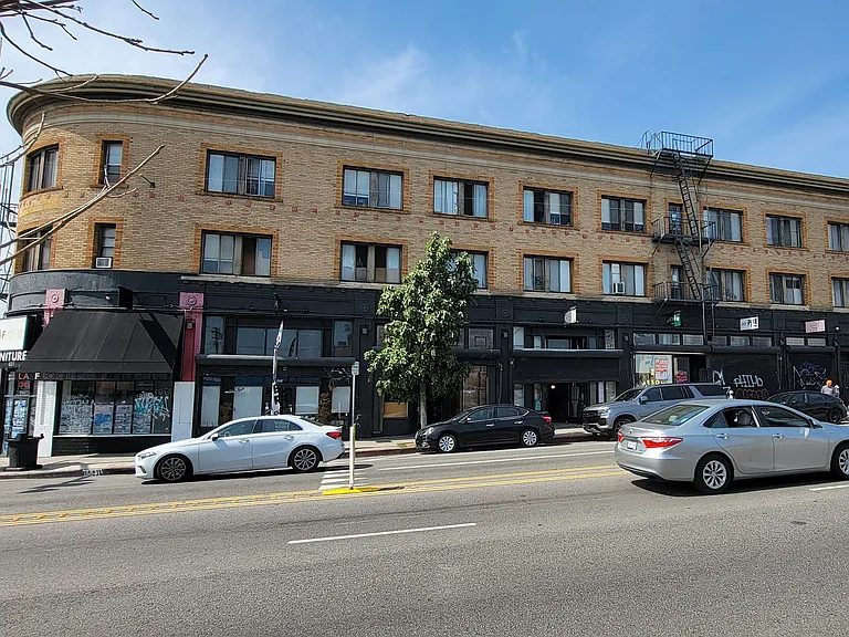 Mid-day street view of the Western at Rosewood apartments in Los Angeles, California.