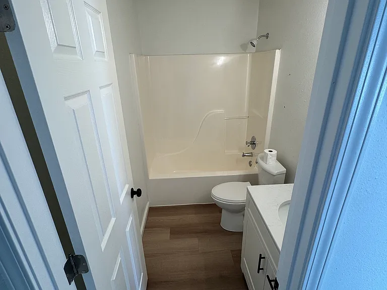 Updated hallway bathroom with tub/shower combo and modern vanity.