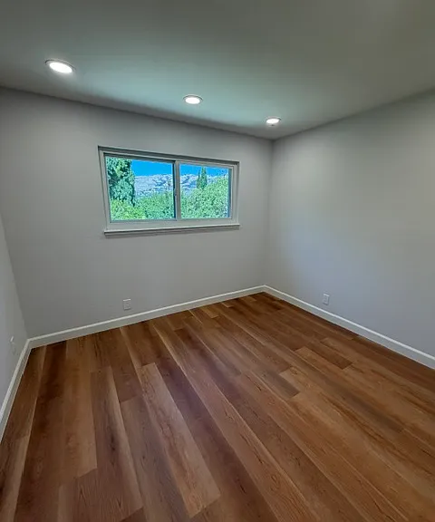 Upper level bedroom with view of backyard.