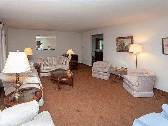 The formal living room offers plenty of space plus updated Pella windows.