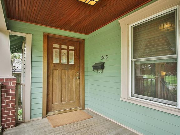 Beautiful front door and painted porch ceiling.