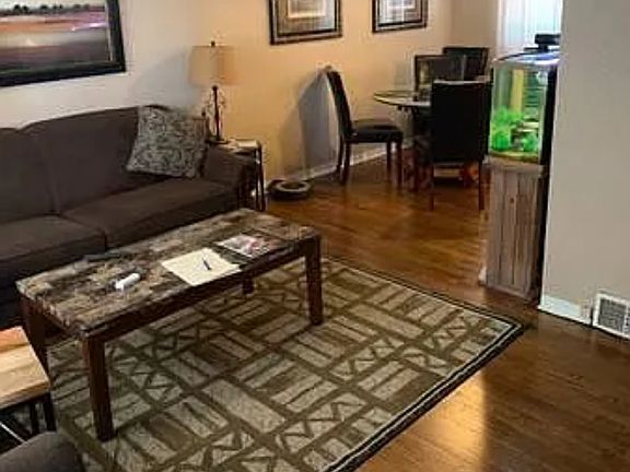 Living room open to dining room with hardwood floors