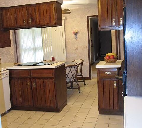 kitchen with cherry cabinets, new electric range, and oven