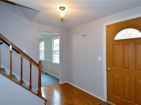 Beautiful Bruce hardwood floors flow from the inviting foyer into the kitchen.