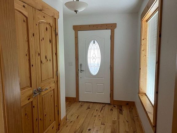 Foyer entry with closet and window
