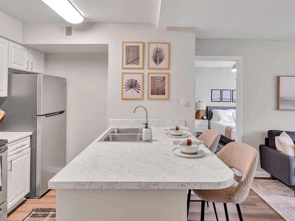 Our kitchens feature a seamless breakfast bar, with stunning white Carrara countertops, creating a bridge between the kitchen masterpiece and the inviting living space.