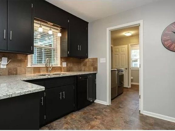 Kitchen with dishwasher and large stainless steel sink