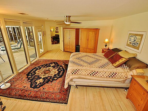 Opposite the TV area is the Master Bedroom with a wall of floor to ceiling windows and access to poo