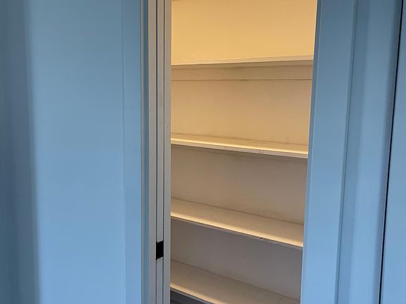 Walk-in kitchen pantry.