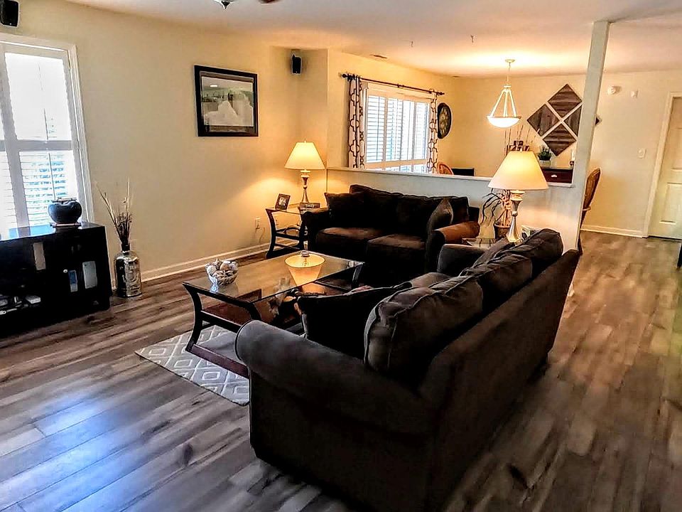 View of the main living area, with the dining area beyond. Guest bed and bath located to your right.