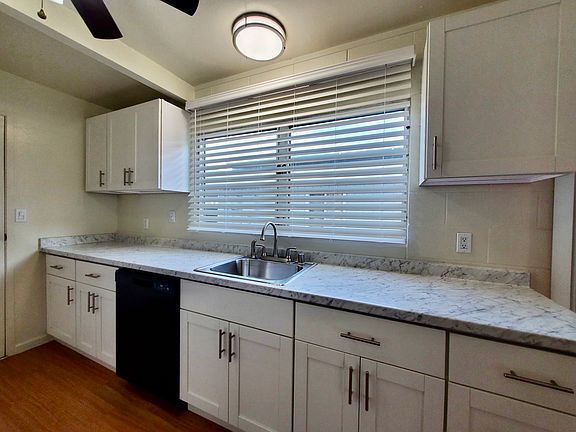 Renovated Kitchen with New Cabinetry, Sink, Faucet, Countertops, Lighting, and Window Coverings