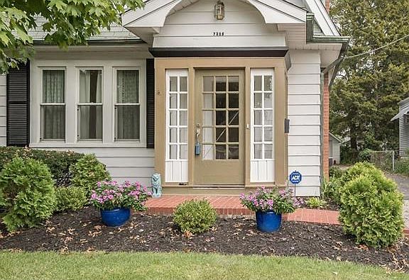 A brick paved walk and porch welcomes your guests and gives hint of the detailed interior.