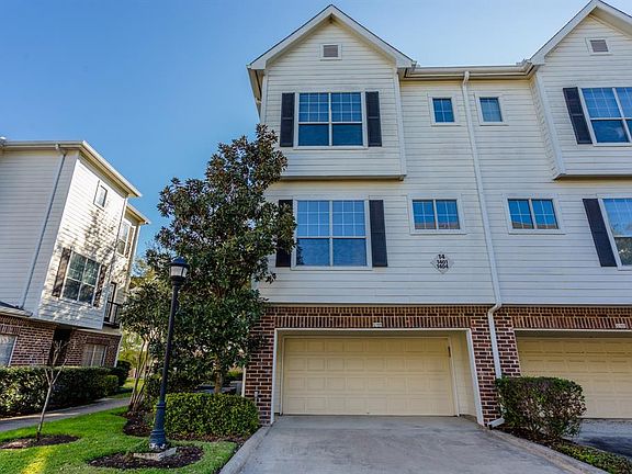A drive at the back of the townhome leads to a double car driveway and two car garage with epoxy flooring. This large driveway provides extra parking for visiting guests but there is also extra parking within close proximity to this home.