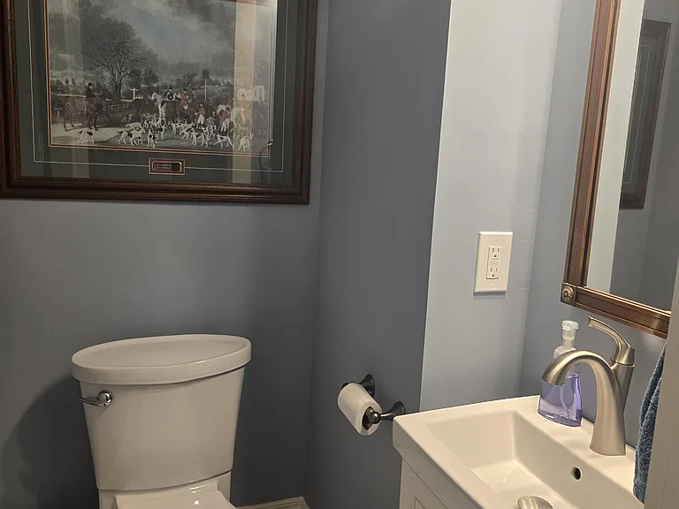 Half bath located off of laundry area and next to side porch entry.