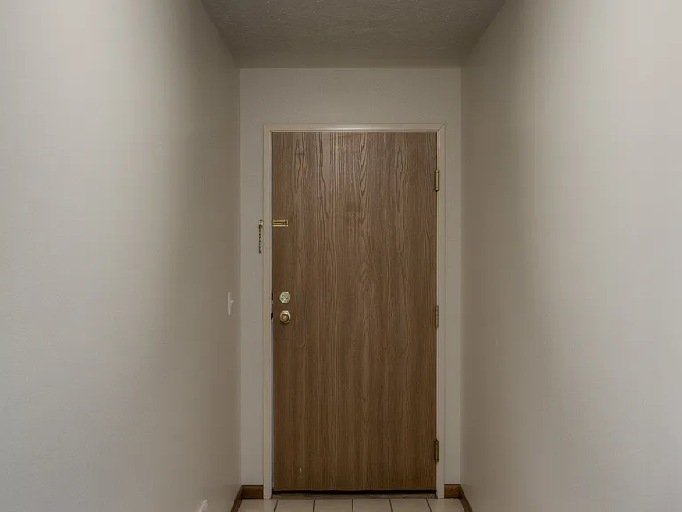 Unit interior front door at Huntington Apartments.
