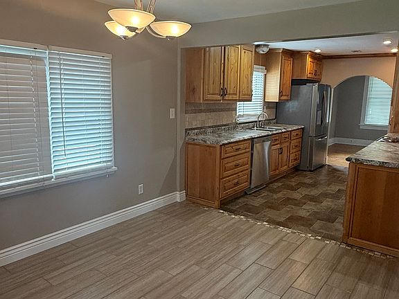 Galley kitchen leading from the front formal dining room to a back kitchenette. Kitchen completely remodeled with custom cabinets and new appliances.