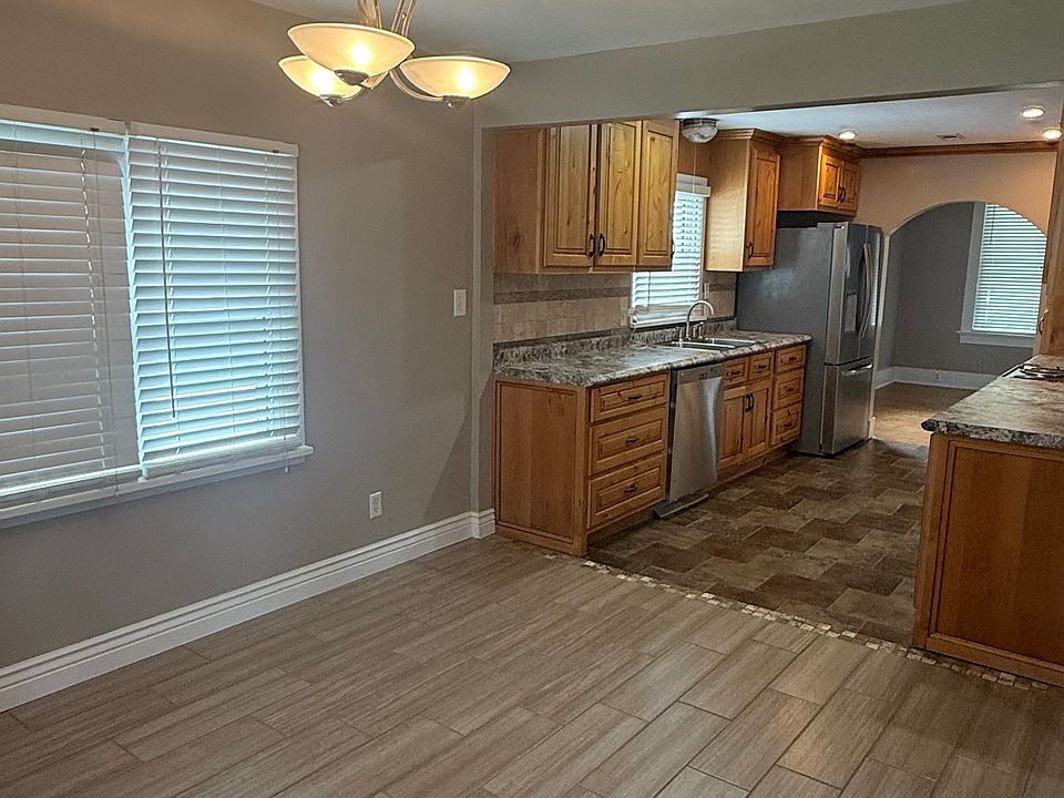 Galley kitchen leading from the front formal dining room to a back kitchenette. Kitchen completely remodeled with custom cabinets and new appliances.