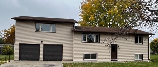 Front of duplex - Upper duplex has access to single garage door on the right side.
