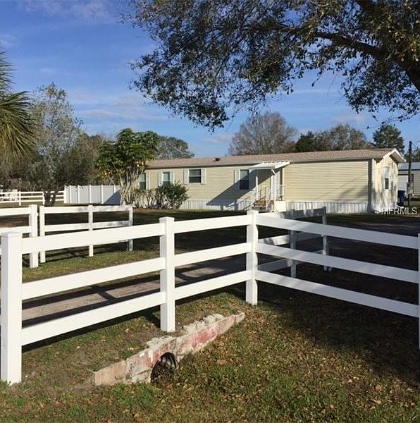 Fenced yard to property entrance.