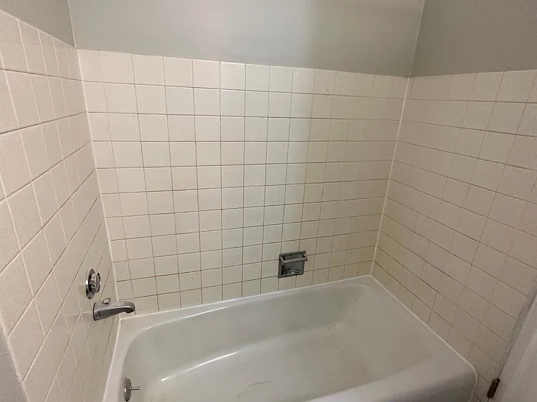 Bathroom 2 in the hallway of the unit with full-size bathtub