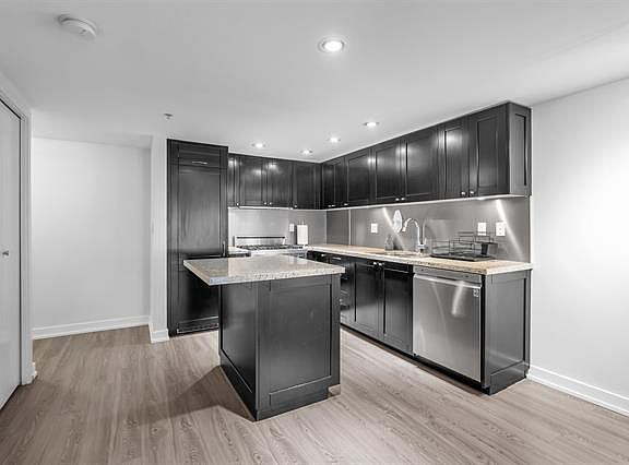 Kitchen with Viking gas stove, stainless appliances, island