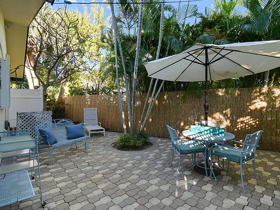 Oversized, multi-use patio includes lots of trees, privacy, bamboo fencing, and enclosed outdoor hot water shower.
