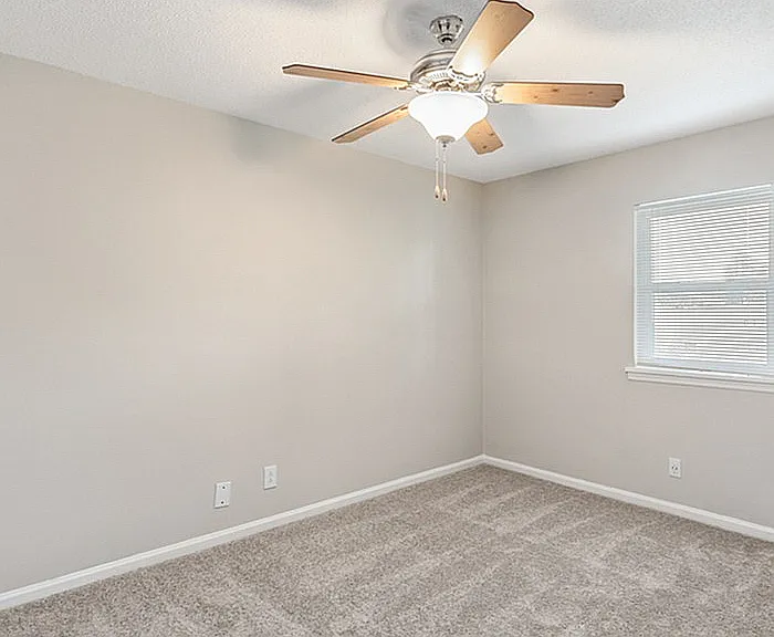 Experience the inviting warmth and spacious design of this cozy room.