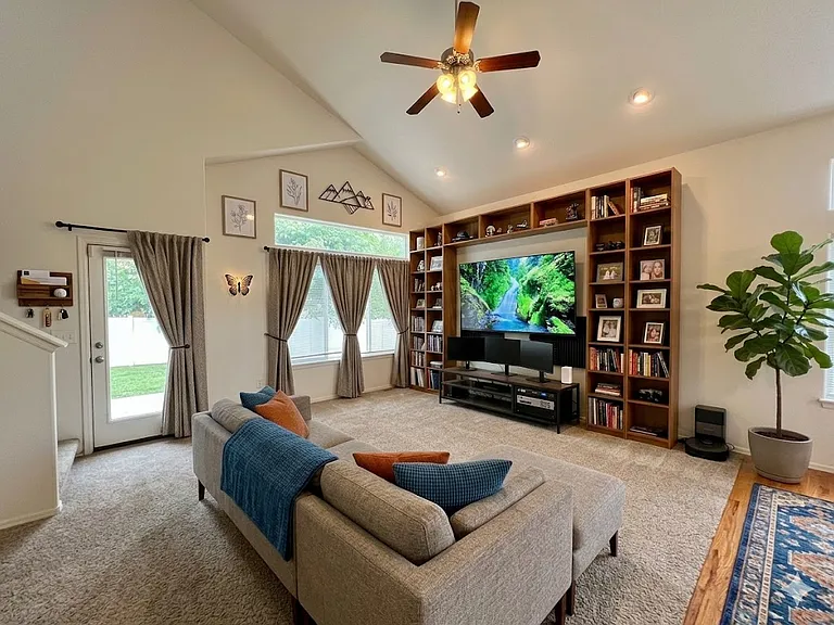 AI decorated living room as viewed from master bedroom archway. NOTE: House is unfurnished.
