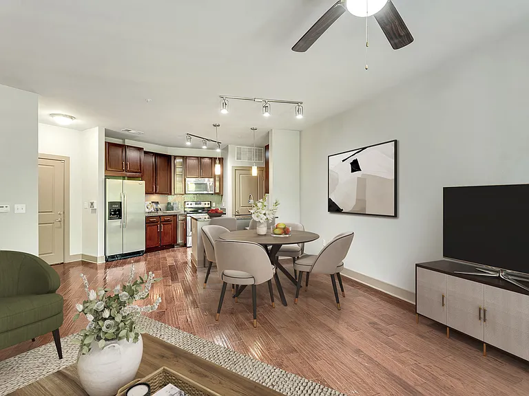 A kitchen with a table and chairs by a window.