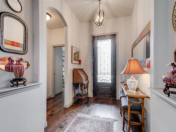 Gracious front entry. Hardwood floors. Art niches. Bronze upgraded lighting. Hallway to left leads to guest suite and bath.