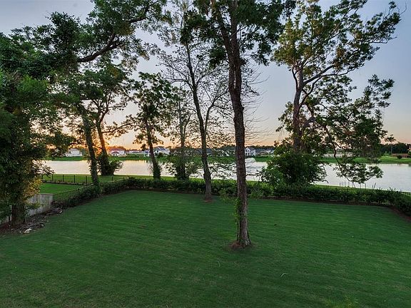 The Pool-sized Backyard looks out over the Expansive Lake with a Sparking Fountain located just behind this home!! The views of the lake are picturesque and the Iron Fence is already there for you!