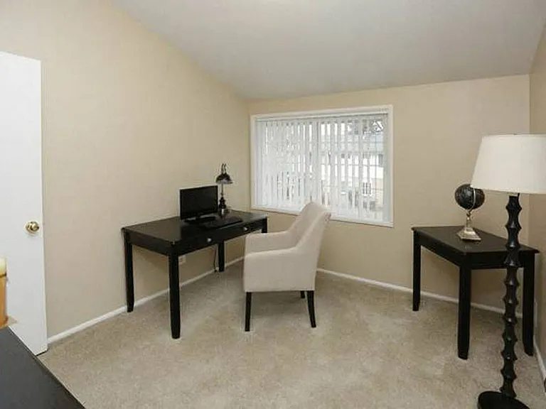 Additional bedroom with plush carpeting in townhome