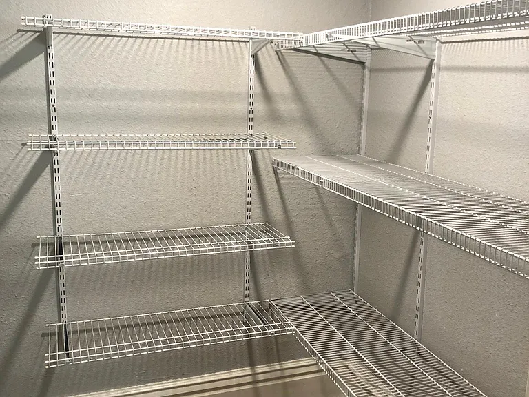 Large walk-in kitchen pantry with lots of shelving and great lighting.