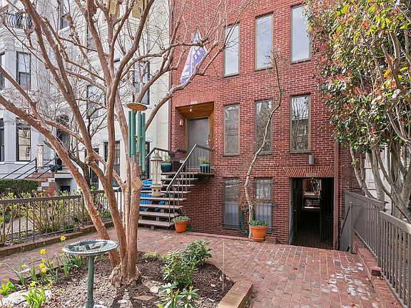Sidewalk view. Note the passageway entrance on left leading to back carriage house