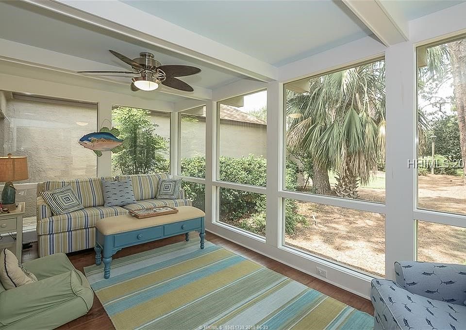 Porch converted to Carolina room in 2012. hardwood floors, beamed ceiling and lots of windows.