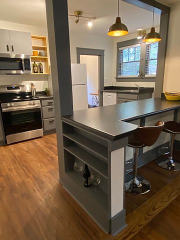 Brand new, custom built open kitchen with lots of shelves.