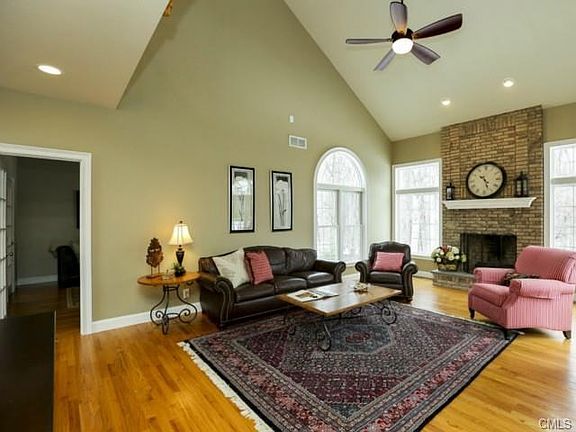 Vaulted ceilings, brick fireplace and large windows looking out
