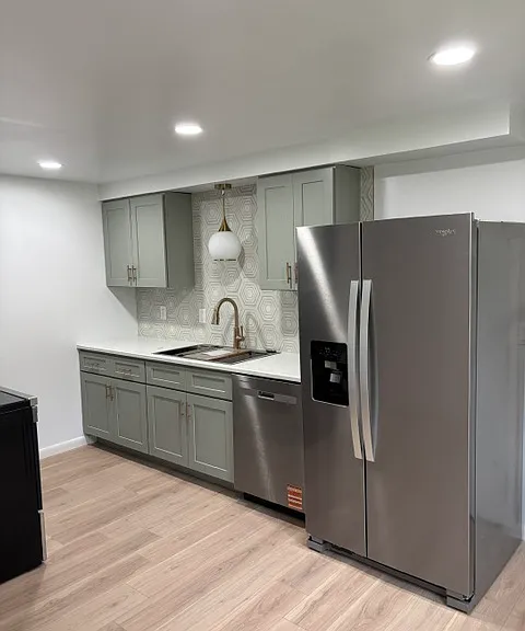 Kitchen with recessed lighting and pendant light above sink