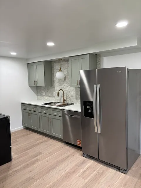 Kitchen with recessed lighting and pendant light above sink