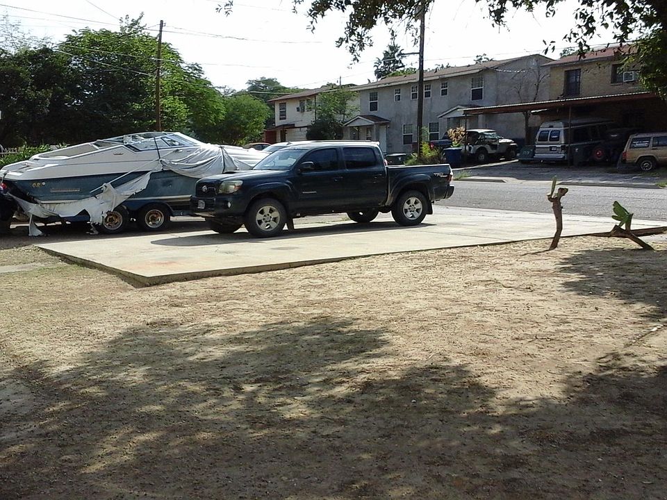 Off-street, concrete parking pad for 2+ cars with 24-hour surveillance camera coverage.