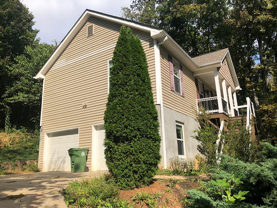 There's a flat concrete pad at the top of the driveway. The front garage goes with the house.