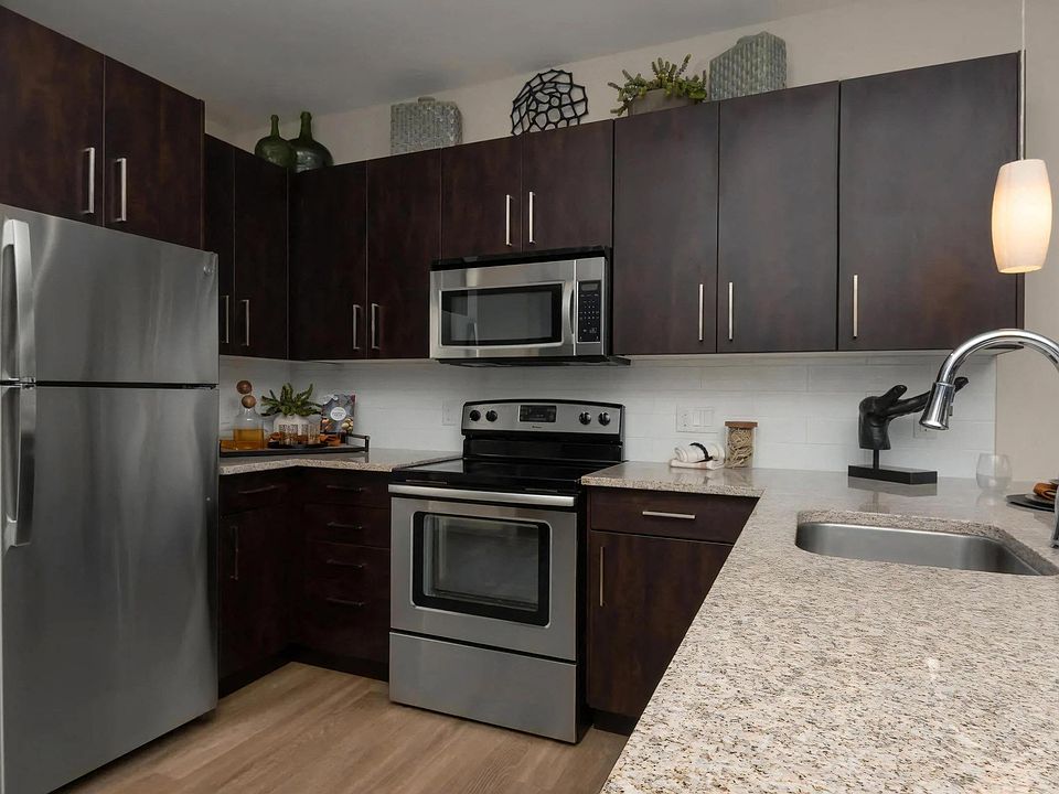 Fully Equipped Kitchen with Granite Counters and Dark Wood Cabinetry