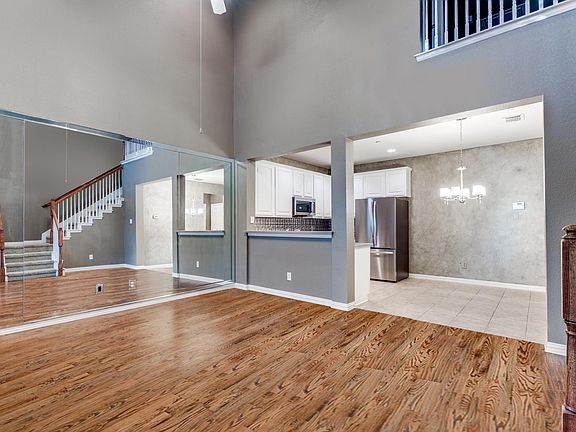 Brand new hardwood floors, inviting living area with soaring ceilings
