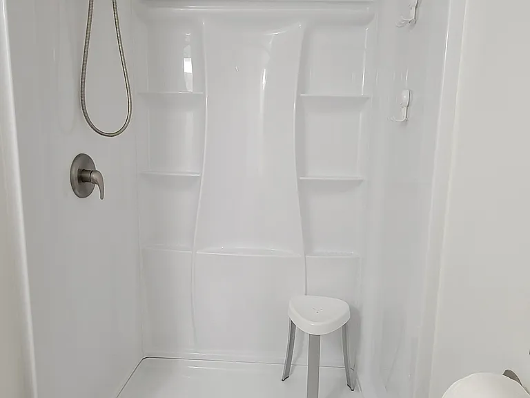 Standup shower with multiple shelves for products; double showerhead