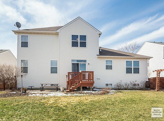 Backyard complete with deck, patio, fence & PEACEFUL FARM SETTING OF OPEN VIEWS BEHIND!