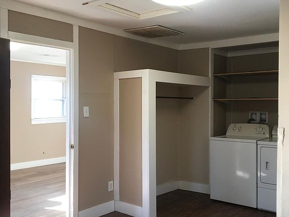 Bedroom with washer and dryer.