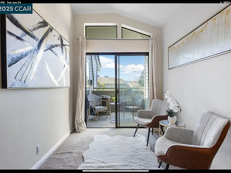 Primary bedroom seating area with small private deck