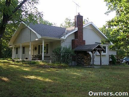 Main House with front porch and convenient wood storage